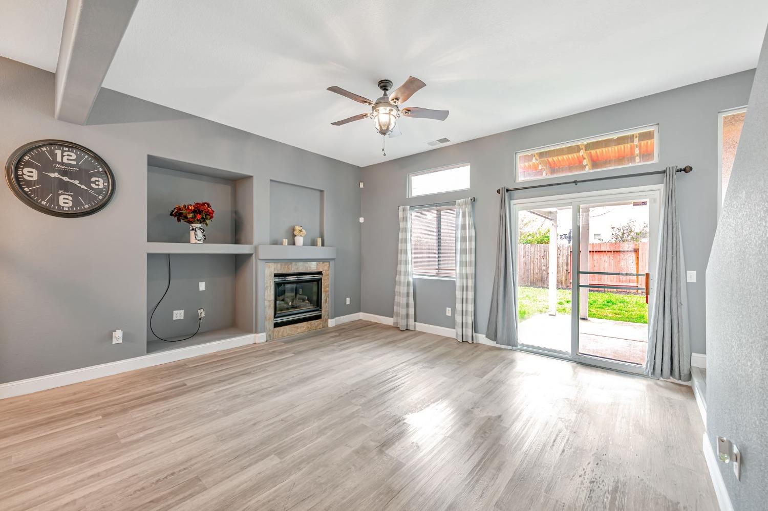9065 Robbins Road Sacramento, CA 95829 - Photo 6 of 45 an empty room with windows and ceiling fan