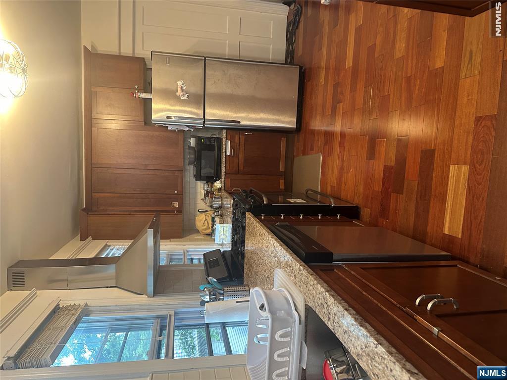 23 Highland Cross, Unit 1 Rutherford, NJ 07070 - Photo 7 of 11 a kitchen with a sink a stove and a refrigerator