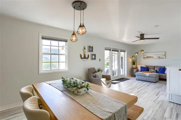 a living room with furniture kitchen view and a window