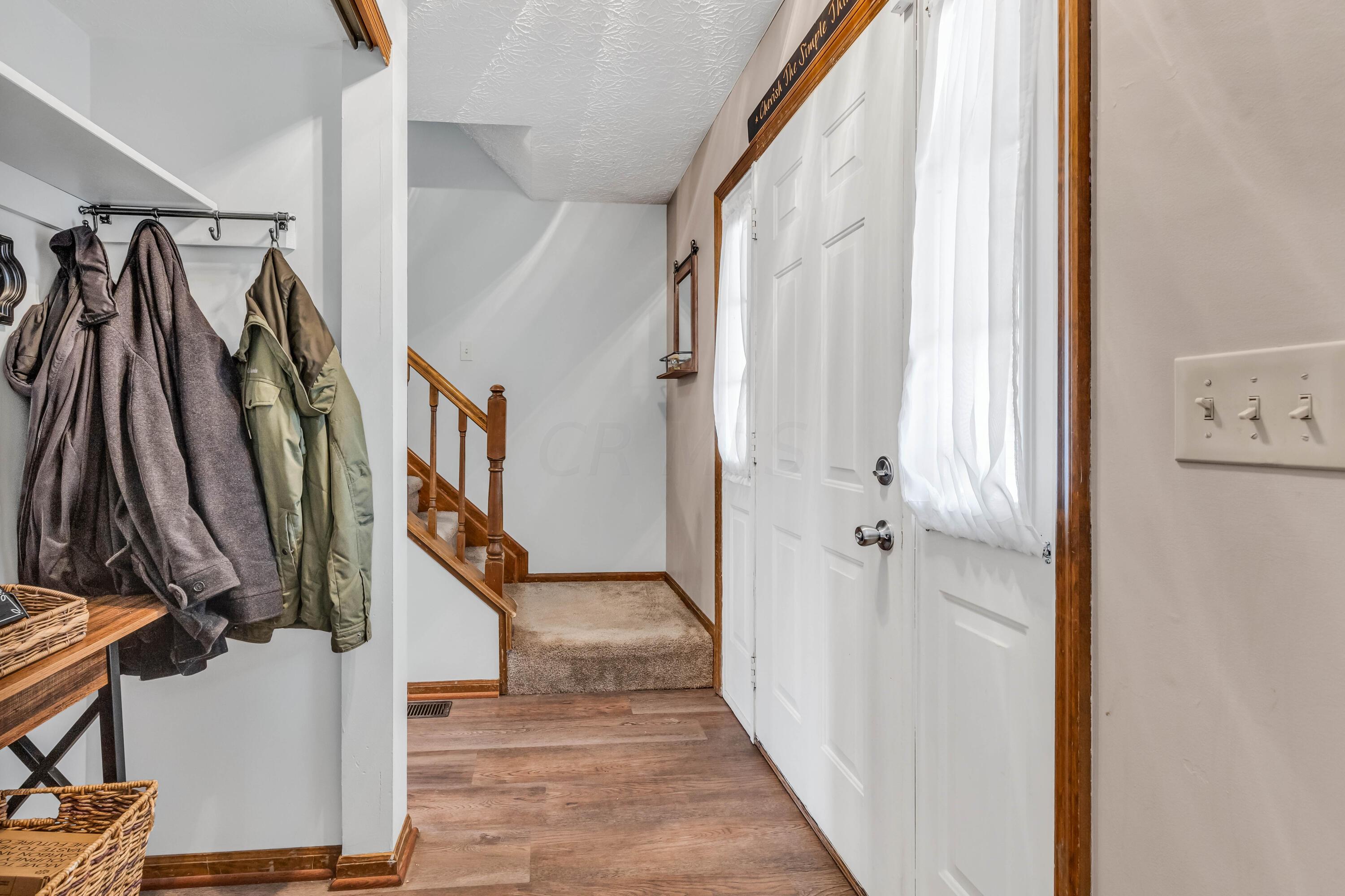 435 Emory Street Gahanna, OH 43230 - Photo 5 of 54 • New luxury vinyl plank
flooring ~ 2022
• Pale grey painted walls
• Side lights by front door
• New ceiling light ~ 2019