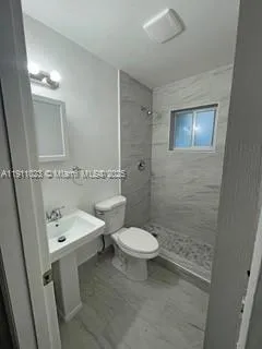 a bathroom with a toilet sink and shower