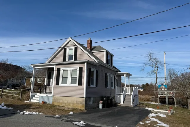 a front view of a house with a street