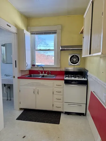 a utility room with sink dryer and washer