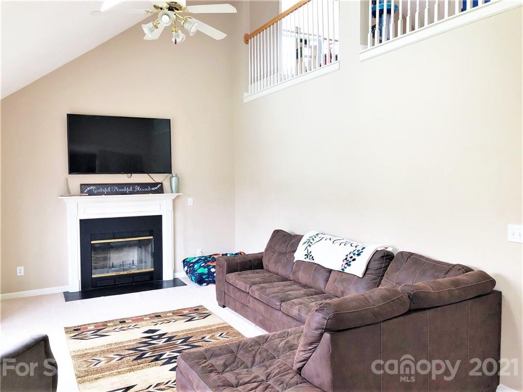 455 English Oak Road Fletcher, NC 28732 - Photo 2 of 6 a living room with furniture a flat screen tv and a fireplace