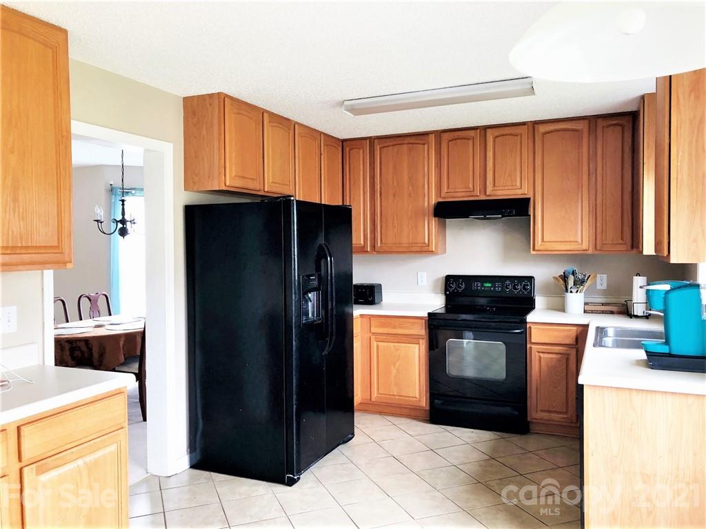 455 English Oak Road Fletcher, NC 28732 - Photo 4 of 6 a kitchen with a refrigerator a stove top oven a washer and dryer