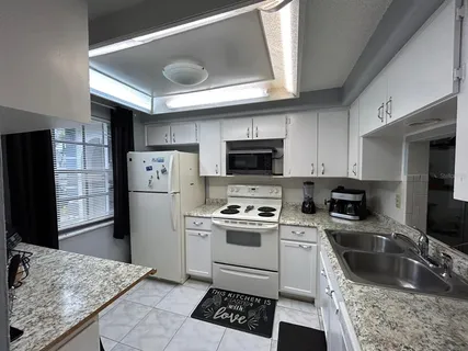 a kitchen with a sink stove and refrigerator