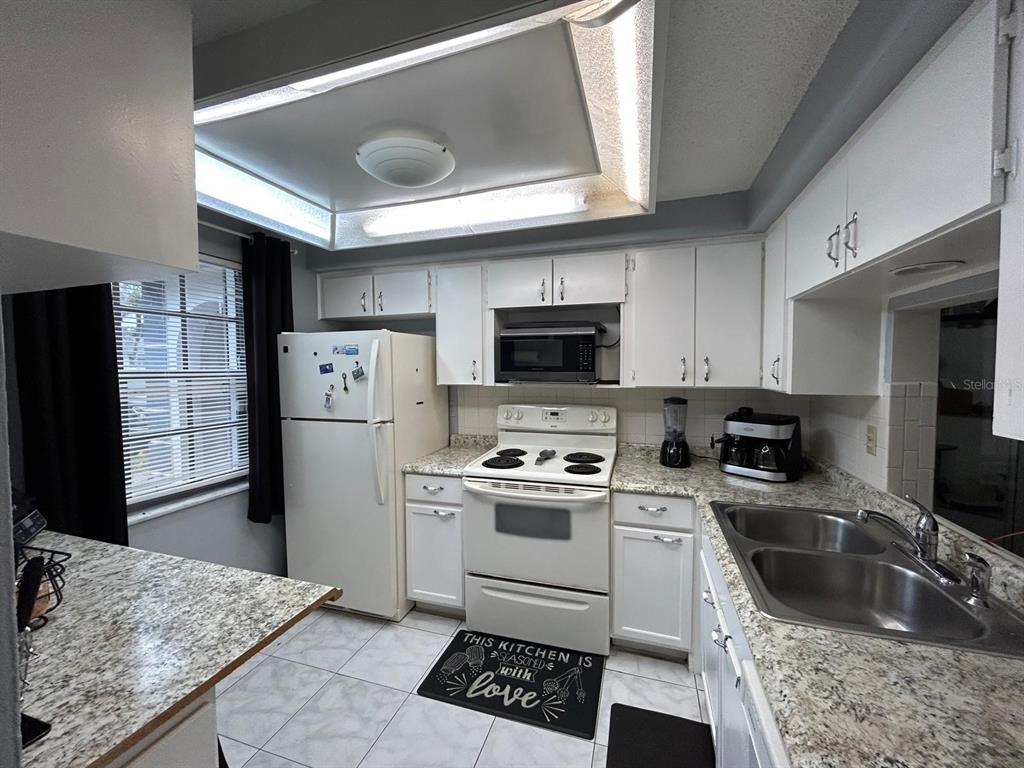 Undisclosed Address New Port Richey, FL 34652 - Photo 5 of 25 a kitchen with a sink stove and refrigerator