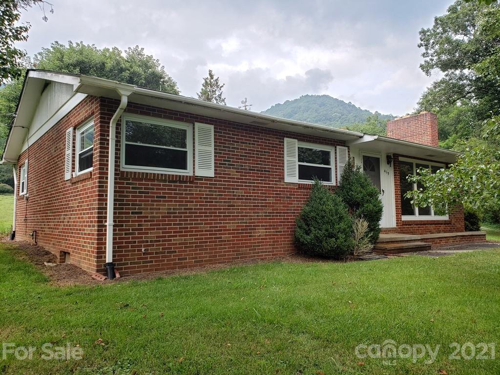 419 Old Michael Road Canton, NC 28716 - Photo 1 of 15 a front view of a house with a garden