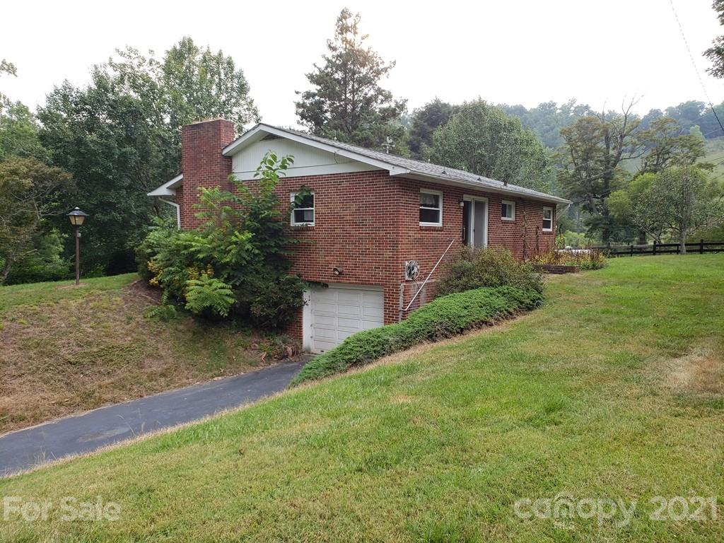 419 Old Michael Road Canton, NC 28716 - Photo 3 of 15 a front view of a house with garden