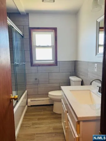 a bathroom with a sink a toilet and bathtub