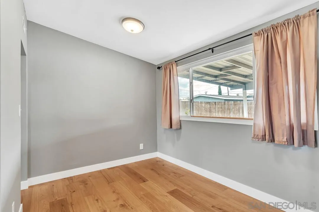 536 Rogue Road El Cajon, CA 92020 - Photo 12 of 24 a view of an empty room with wooden floor and a window