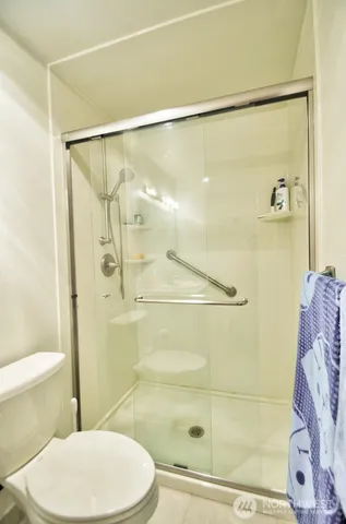 a bathroom with a toilet and shower