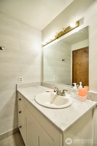 a bathroom with a sink and a mirror