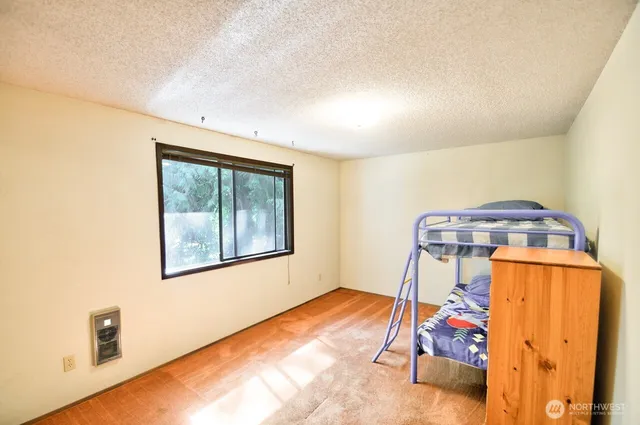 a view of a room with furniture and wooden floor