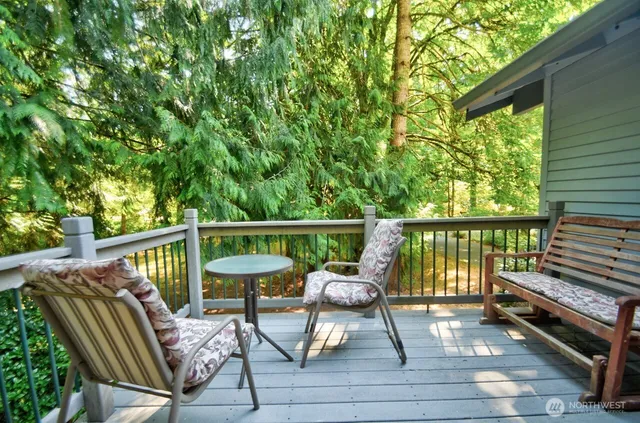 a view of balcony with wooden floor and outdoor seating