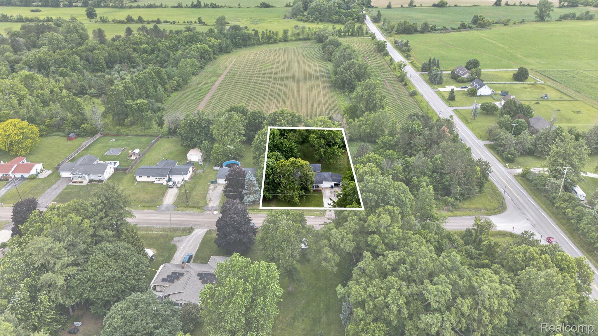 9288 Hilda Lane Flushing, MI 48433 - Photo 50 of 50 Aerial property overview highlighting a residential structure within a wooded parcel