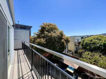 a balcony with wooden floor and city view