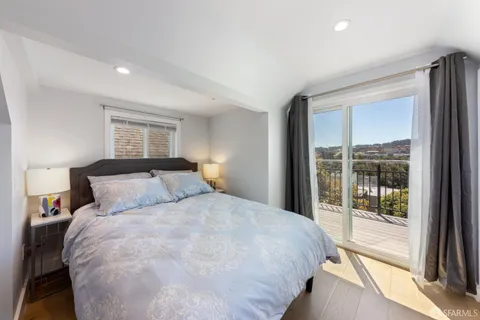 a large bedroom with a bed and a large window