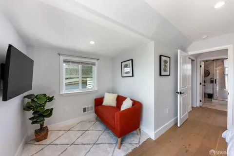 a living room with furniture and a potted plant