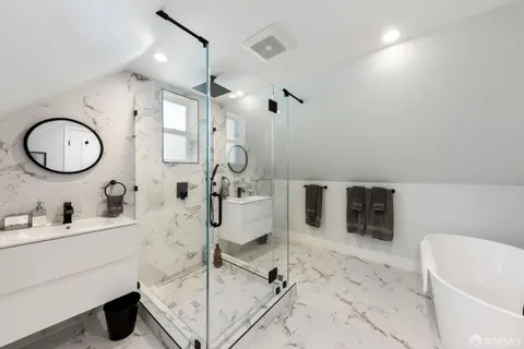 a bathroom with a sink a toilet and a mirror