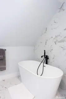 a white bath tub sitting in a bathroom