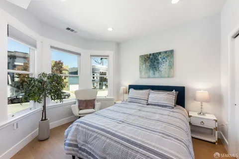 a bedroom with a large bed and a window