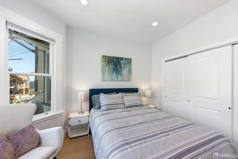 a bedroom with a bed and glass window