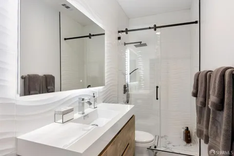 a bathroom with a sink toilet and shower