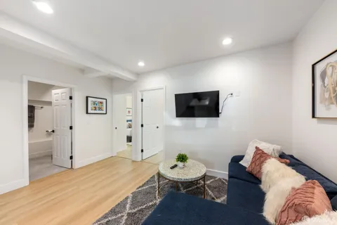 a bedroom with a bed and a flat screen tv