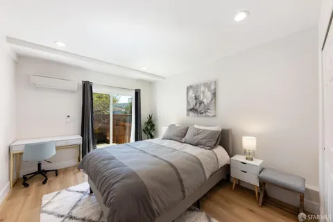 a bedroom with a bed and a large mirror