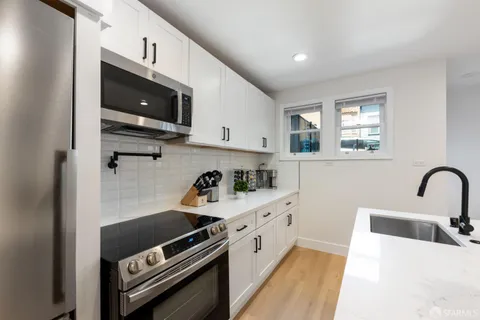 a kitchen with a stove and a microwave