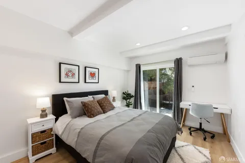 a bedroom with a bed and a desk