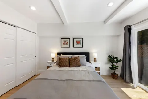 a bedroom with a bed and a potted plant