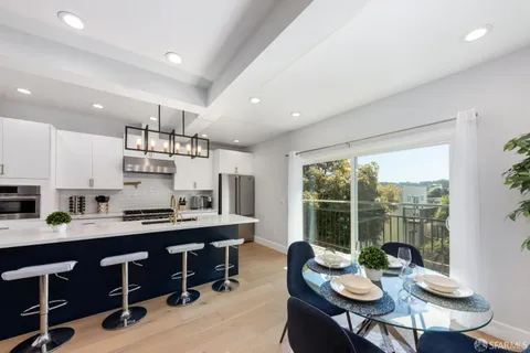 a kitchen with a table chairs stove and kitchen island