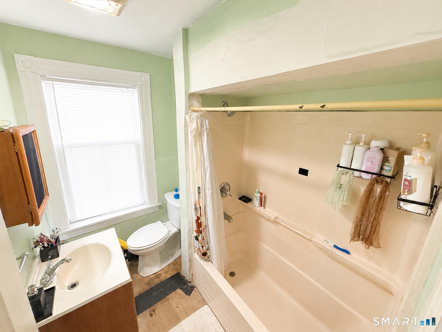 98 Huntington Road Bridgeport, CT 06608 - Photo 14 of 15 a bathroom with a tub a sink and a shower