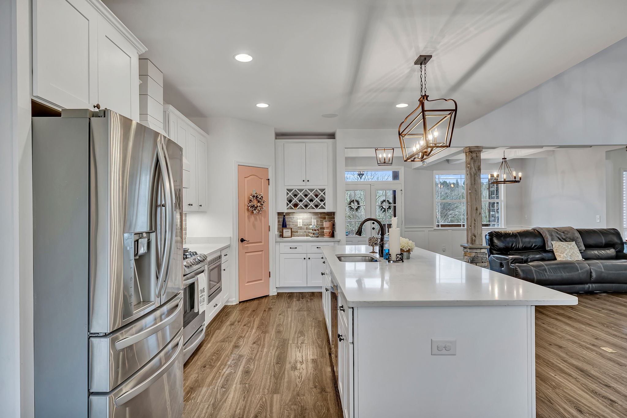 1349 Cliff Amos Road Spring Hill, TN 37174 - Photo 11 of 48 a kitchen with stainless steel appliances kitchen island granite countertop a refrigerator a sink dishwasher a oven and a dining table with wooden floor