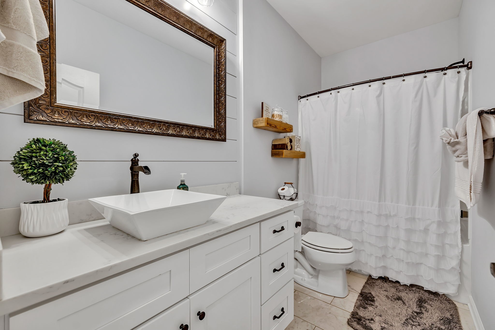 1349 Cliff Amos Road Spring Hill, TN 37174 - Photo 18 of 48 a bathroom with a sink a toilet and shower curtain