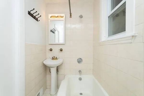 a bathroom with a sink a mirror and a bathtub