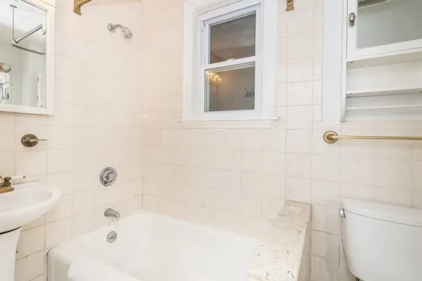 a bathroom with a bathtub and a toilet