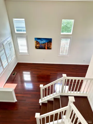 a view of entryway with wooden floor and stairs