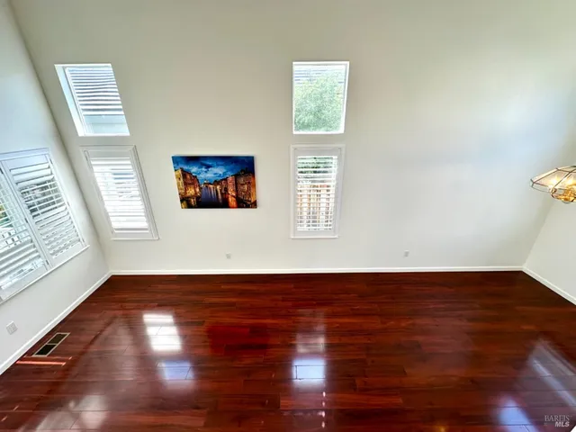 a view of a kitchen with wooden floor and electronic appliances
