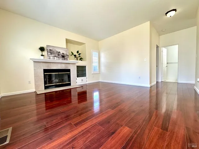 a view of a livingroom with furniture hardwood floor and a ceiling fan