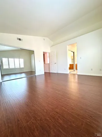 a view of a room with wooden floor