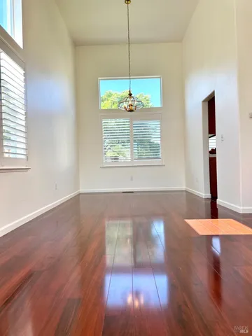 a view of a room with wooden floor and a window