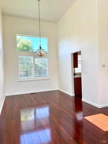 a view of a room with wooden floor and window