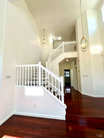 a view of staircase with white walls and a potted plant