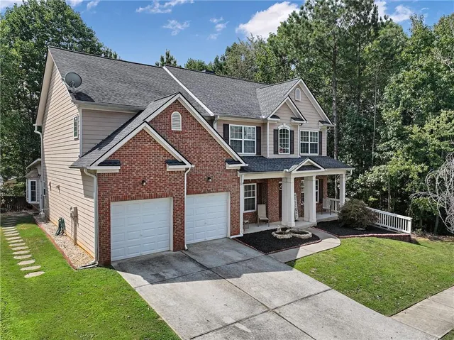 an aerial view of house with yard and mountain view in back