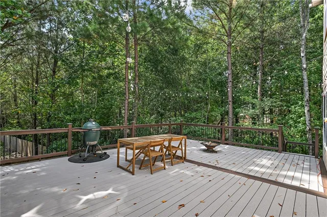a room with pool table windows and wooden floor