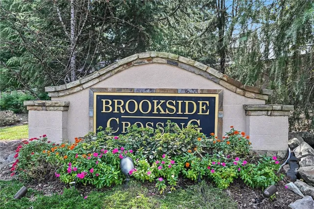 a kitchen with stainless steel appliances kitchen island granite countertop a refrigerator and a stove top oven