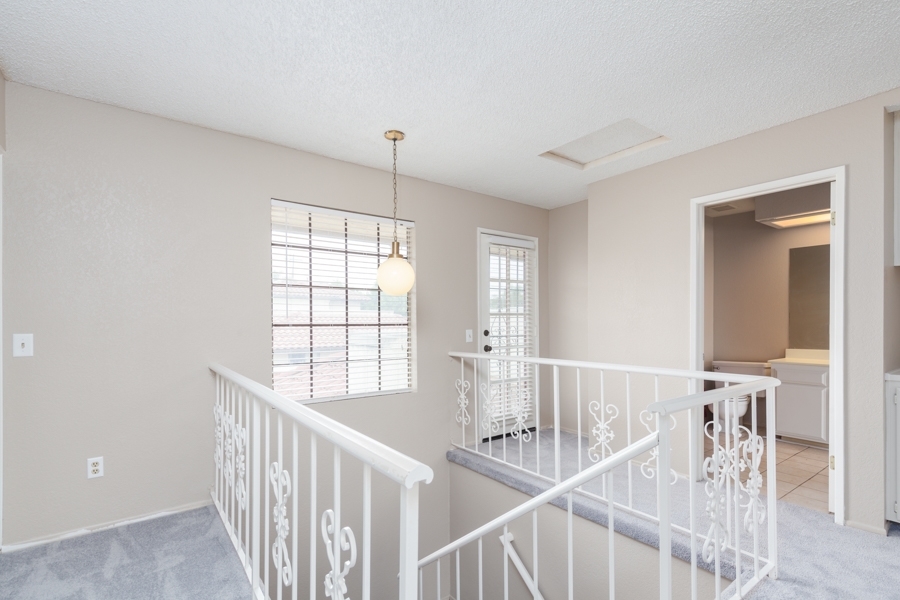 320 Grapevine Road, Unit 114 Vista, CA 92083 - Photo 5 of 21 Center stairway to nice open hallway, access to upstairs indoor laundry room with door to patio/deck above garage.